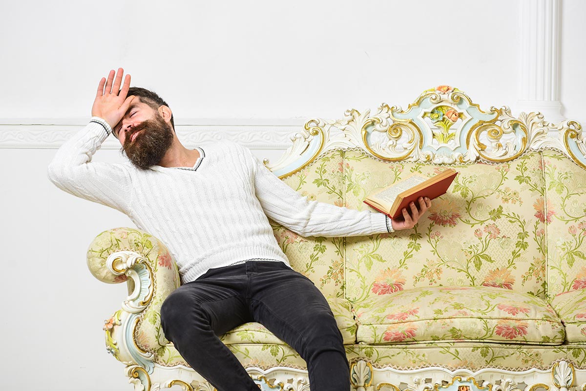 Empathetic man swooning over a passage in a book