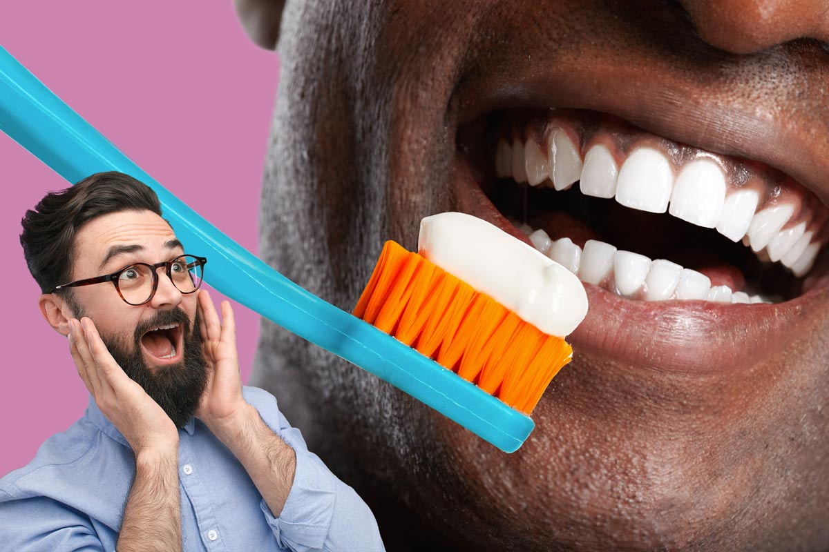 close-up of man's healthy gums as he brushes them