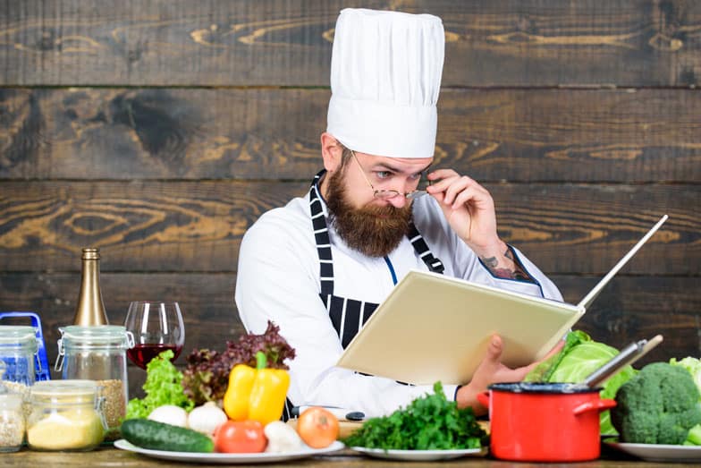 Chef reading cook book
