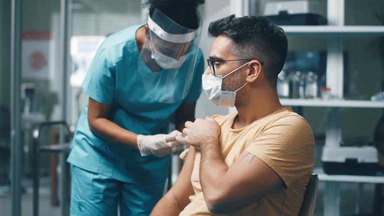 Man getting adminsitered the COVID-19 vaccine during the pandemic