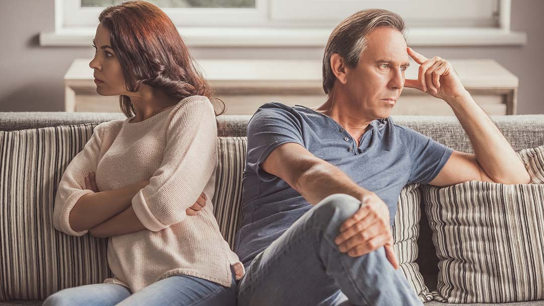 Couple on sofa feeling disconnected