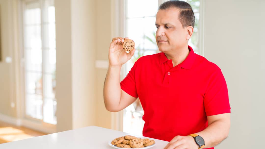 South Asian man stress eating