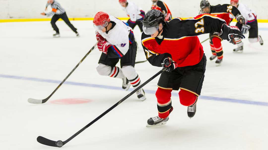 Men playing beer league hockey