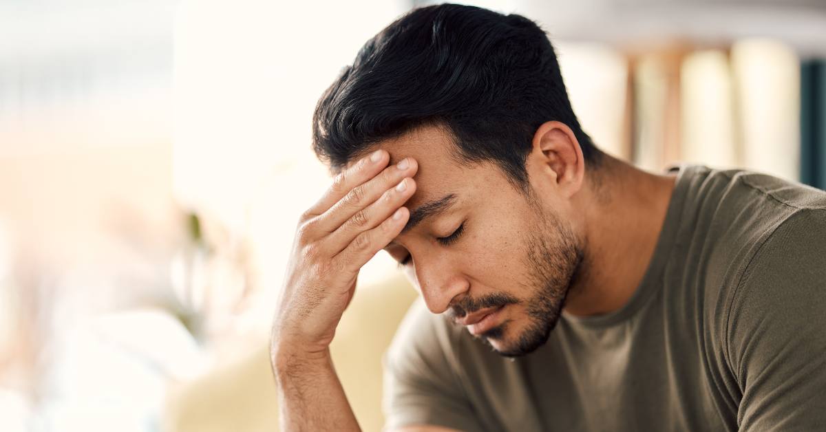 Tired, headache and stress of man in living room