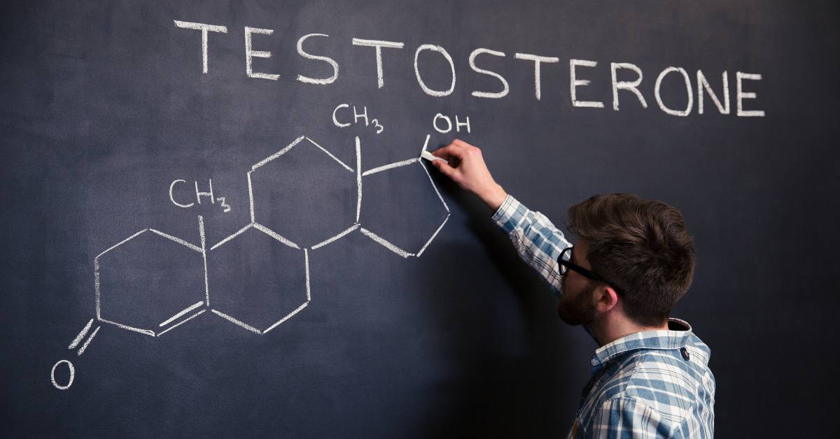 man writing testosterone on black board