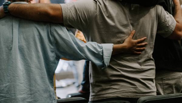 A Group of men supporting each other in therapy