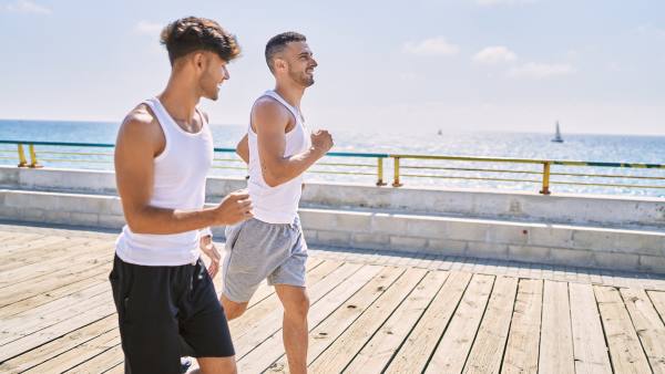 a group of men running on a dock