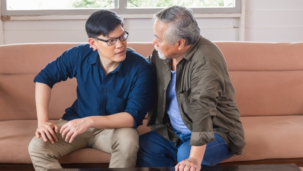 men talking on couch