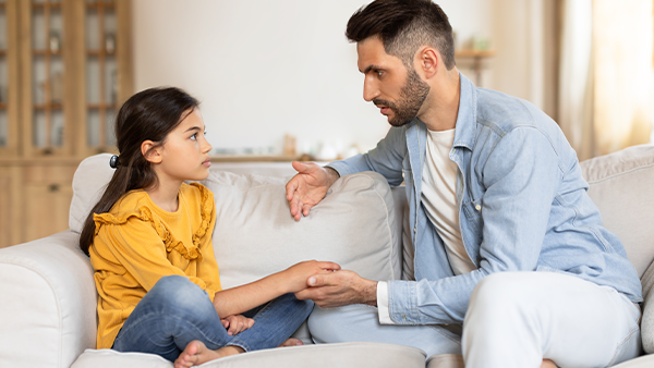 father having a serious conversation with is preteen