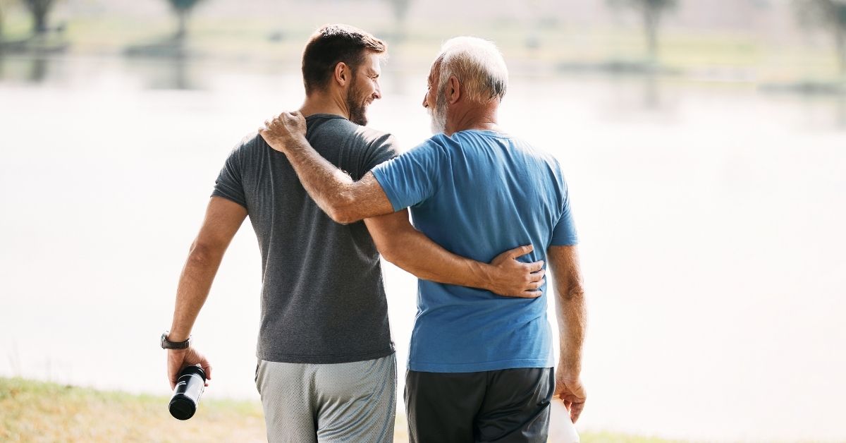 father son walking with arms around one another