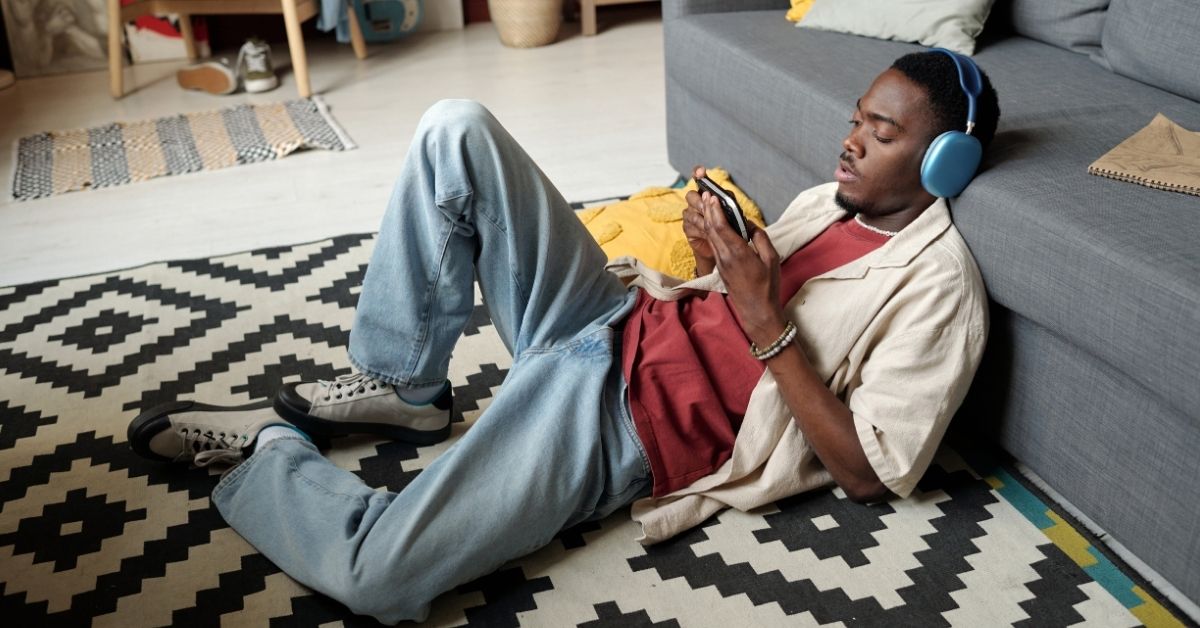 guy relaxing with phone and headphones