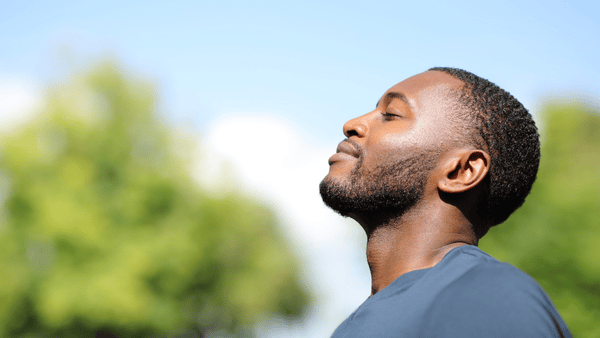 man with eyes closed looking content