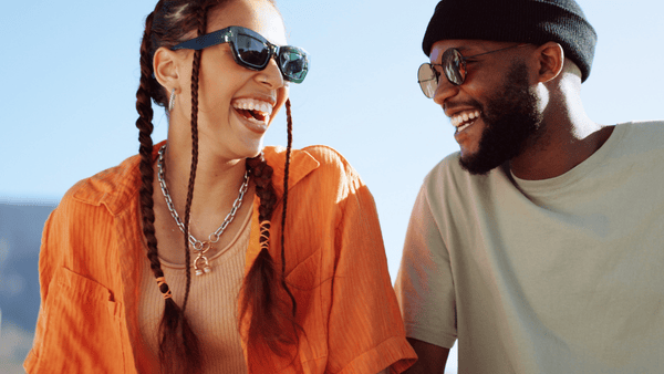 young guy and girl looking at each other laughing