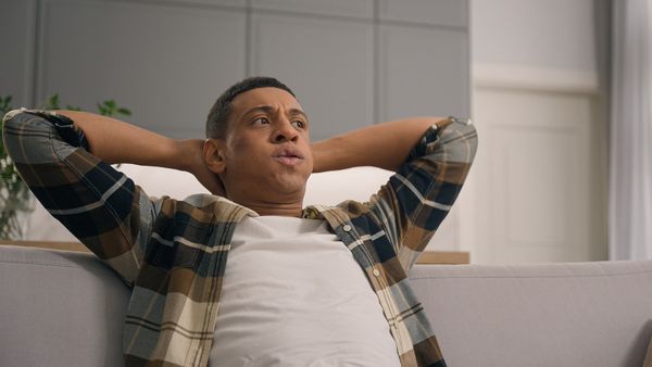 man taking time to calm down on couch